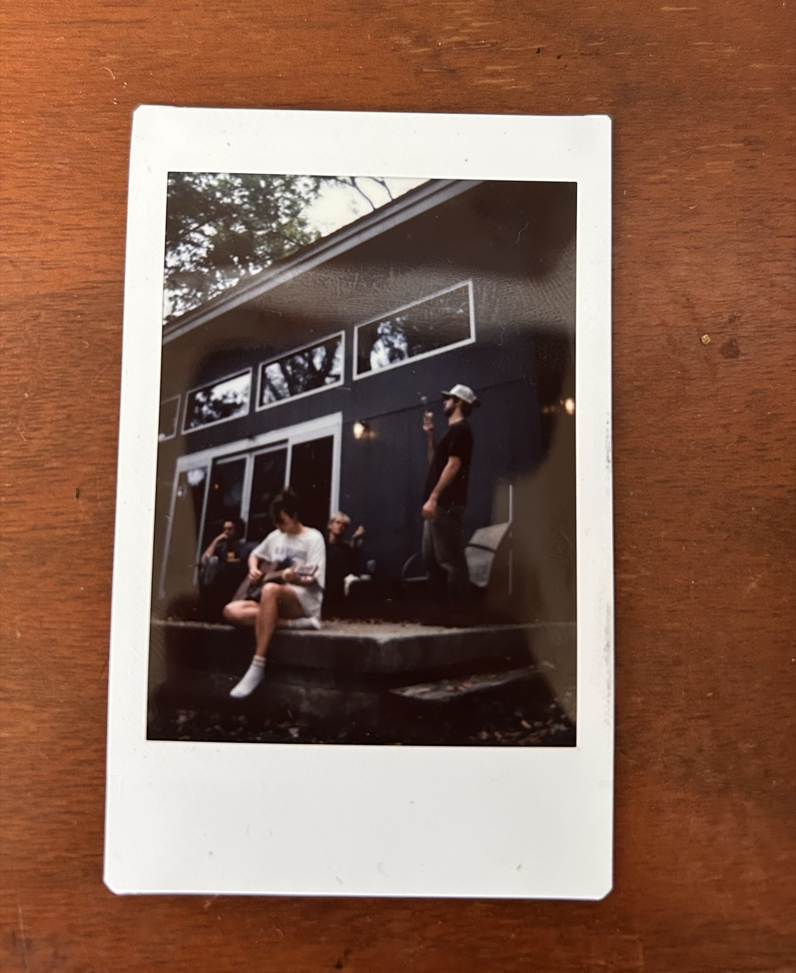 Volume 2 album cover — an instax print of Blackberry Martin on a porch, lying on a wooden table